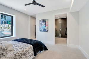 Bedroom featuring recessed lighting, baseboards, a ceiling fan, and ensuite bathroom