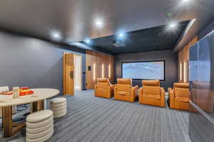 Home theater featuring carpet, recessed lighting, and a tray ceiling