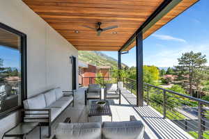 Balcony with an outdoor living space, a mountain view, and ceiling fan