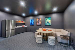 Rec room featuring dark carpet, recessed lighting, baseboards, and a sink