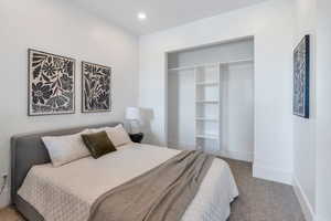 Bedroom with carpet floors, baseboards, a closet, and recessed lighting
