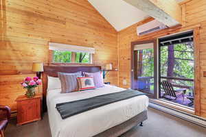 Master bedroom King bed, wall mounted AC and heat, lofted ceiling, and access to exterior deck