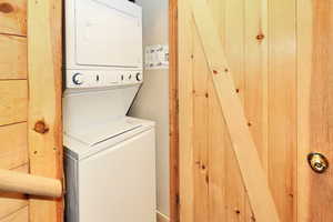 Laundry room featuring stacked washer and dryer