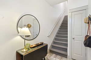 Stairway featuring wood finished floors