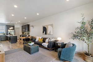 Living room featuring light wood finished floors and recessed lighting