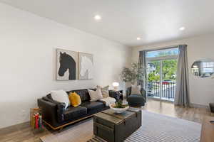 Living room featuring wood finished floors, baseboards, and recessed lighting