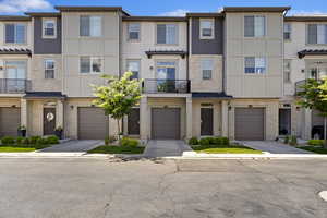 Townhome / multi-family property with an attached garage and driveway