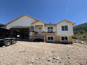 View of front facade with a garage and a mountain view
