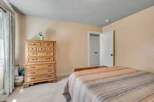 Carpeted bedroom featuring baseboards