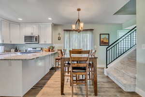 Dining room featuring stairway, healthy amount of natural light, recessed lighting, and light wood-style floors