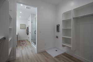 Mudroom with light wood-type flooring, baseboards, and recessed lighting