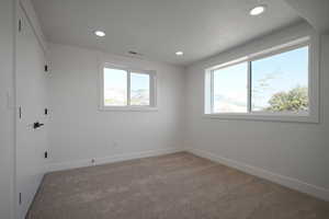 Unfurnished room featuring carpet flooring, recessed lighting, and baseboards