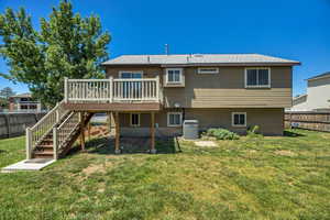 Back of property with a deck and stairs