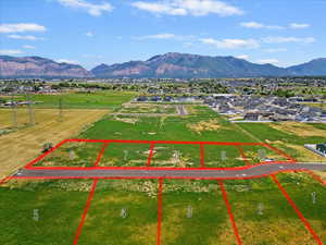 Aerial view of property and surrounding area featuring property boundaries highlighted and mountains