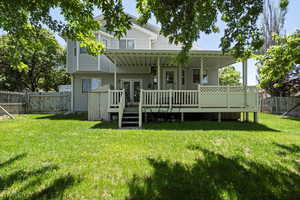 Back of house with a wooden deck, a gate, and french doors