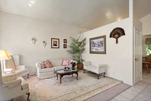 Living room with baseboards and light tile patterned flooring