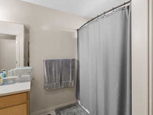 Full bath with vanity and a shower with shower curtain