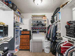 Walk in closet with carpet flooring