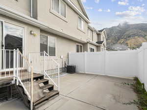 View of patio with a mountain view and central air condition unit