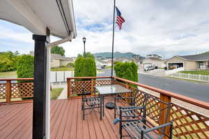 Wooden terrace with a residential view and outdoor dining area