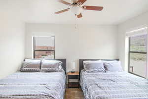 Carpeted bedroom featuring a ceiling fan