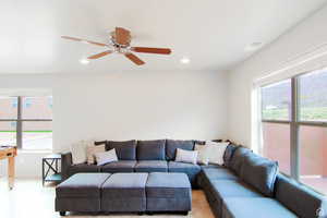 Living area with healthy amount of natural light, ceiling fan, and recessed lighting