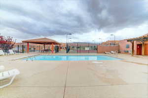 Community pool with a patio area and a gazebo