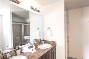 Bathroom with double vanity and a shower stall