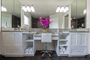 Full bath featuring vanity, tile patterned flooring, and a tile shower