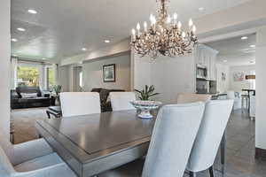 Dining space with recessed lighting, a textured ceiling, and a chandelier