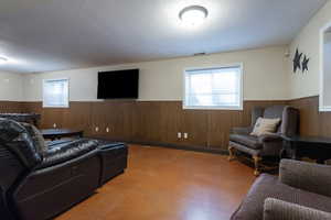 Living room with a wainscoted wall and wood walls