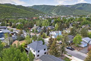 Aerial perspective of suburban area with a mountainous background