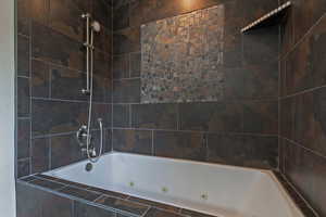 Bathroom featuring a combined bath / shower with jetted tub