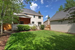 Back of property with roof with shingles