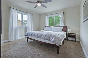 Bedroom featuring carpet, baseboards, and ceiling fan