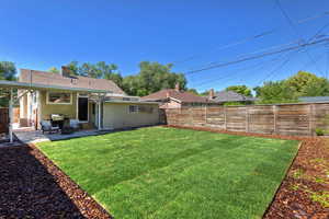 View of yard with entry steps and a patio