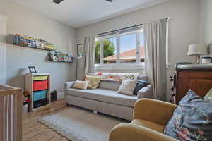 Living room with wood finished floors and a ceiling fan