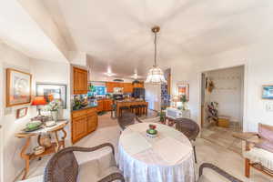 Semi-formal dining room featuring a chandelier, breakfast bar and kitchen.