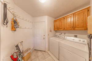 Laundry room featuring cabinet space, washer and dryer