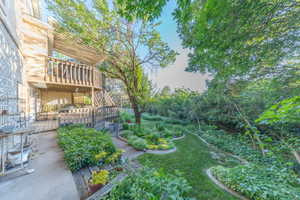 View of yard with a beautiful wooden deck.