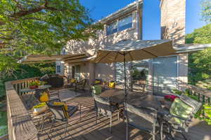 Deck with outdoor dining area and a grill