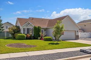 View of front facade with an attached garage, concrete driveway, and a shingled roof