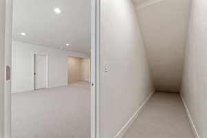 Hallway featuring carpet, recessed lighting, baseboards, and a textured ceiling