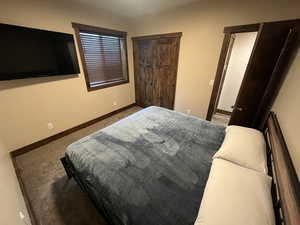 Bedroom with baseboards and carpet flooring