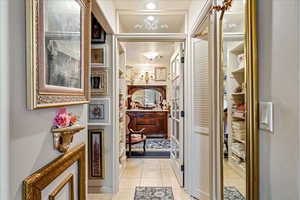 Hallway with light tile patterned floors