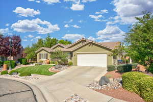 Single story home with stucco siding, concrete driveway, a garage, a front yard, and a tiled roof