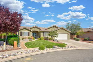 Ranch-style home with a garage, stucco siding, driveway, and a tile roof