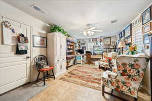 Office space with a ceiling fan and built in desk