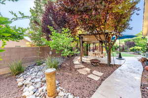 View of yard featuring an outdoor fire pit and a patio area