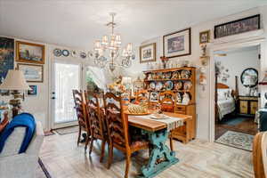 Dining room featuring a chandelier and vaulted ceiling